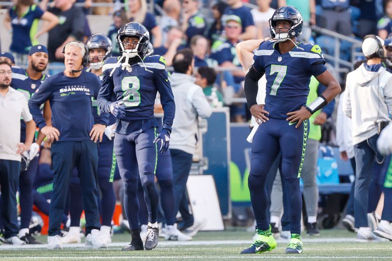 Seattle Seahawks head coach Pete Carroll and quarterback Geno Smith look up at the scoreboard after Smith threw an interception on fourth down effectively ending the game during the fourth quarter, Sunday, Sept. 25, 2022, in Seattle. (Jennifer Buchanan / The Seattle Times)