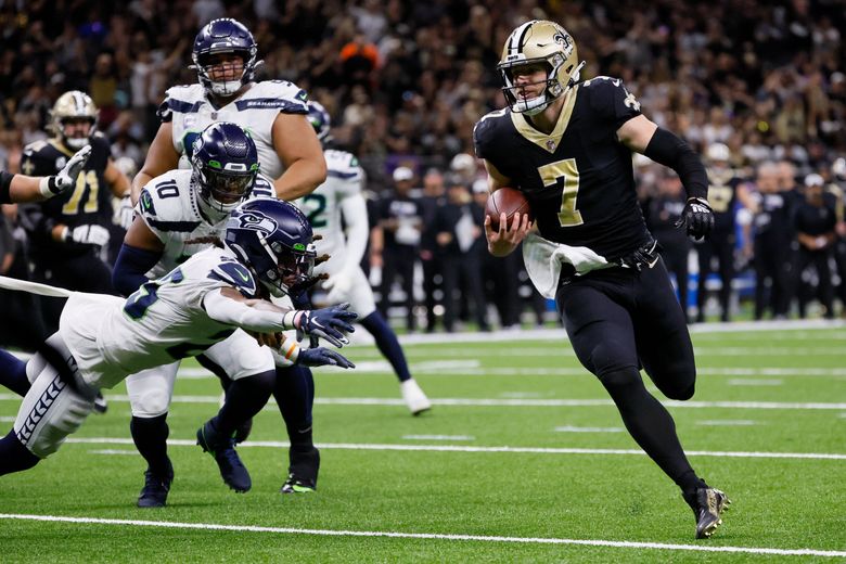 New Orleans Saints’ Taysom Hill scrambles past the Seattle Seahawks defense for a touchdown during the second quarter. (Jennifer Buchanan / The Seattle Times)