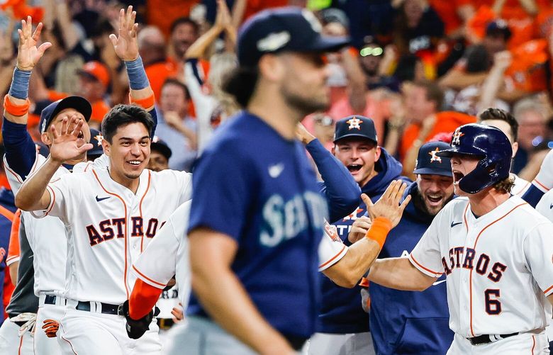 Robbie Ray walks off while the Astros celebrate their walkoff win over the Mariners in Game 1 of the AL Division Series.
