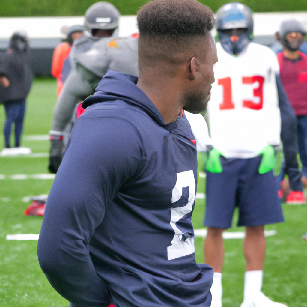 Devon Witherspoon, Seattle Seahawks' First-Round Draft Pick, Observes Practice from Sidelines